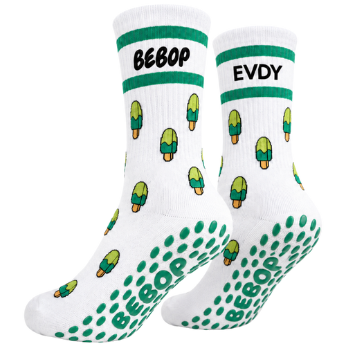 A pair of white crew socks with green and black graphics. The top cuff features a green stripe with the text 'BEBOP' on one sock and 'EVDY' on the other.